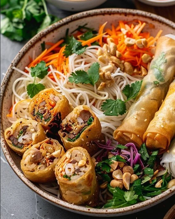 Delicious Thai Peanut Spring Roll Noodle Bowl topped with fresh vegetables and peanut sauce