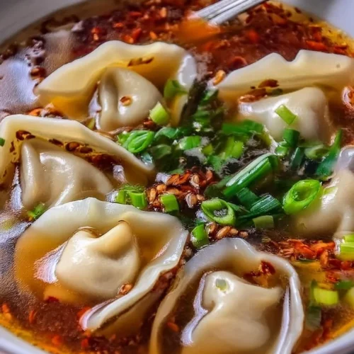 Bowl of homemade weeknight wonton soup with green onions and broth