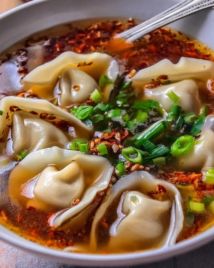 Bowl of homemade weeknight wonton soup with green onions and broth